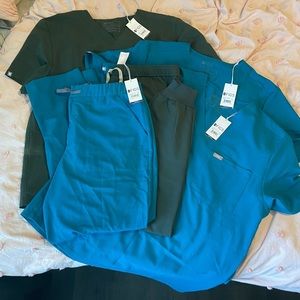 Two sets of men’s 2XL FIGS, dark olive and Caribbean blue